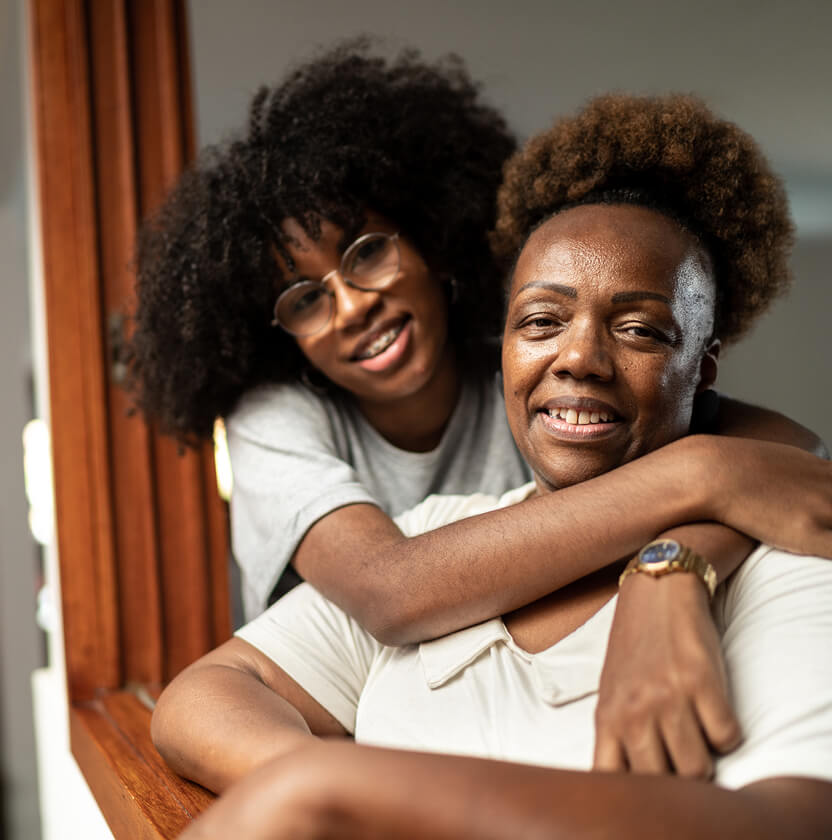 Teenage girl hugging older woman